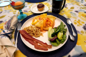Port_Austin_Bed_and_Breakfast_Port_Austin_Michigan_Hotel_Image 26 - Port Austin Bed & Breakfast Breakfast plate with peach crepes, bacon, salad and hash browns. Also a bowl of mango sorbet, a cup of coffee and a profiterole.