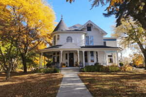 PABB house in the fall with pumpkins on the porch.